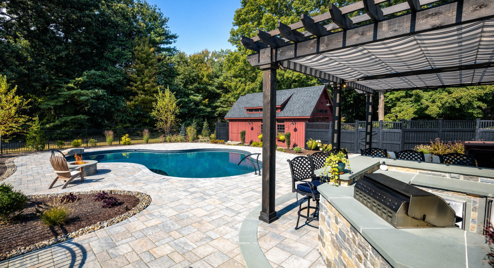 Pool with a cabana and bbq area.