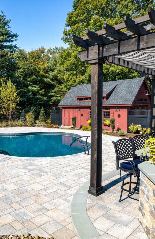 Pool with a cabana and bbq area.