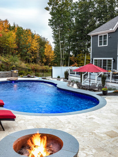 Chairs and fire pits surrounding a pool.