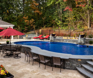 Backyard pool with bar built into pool.