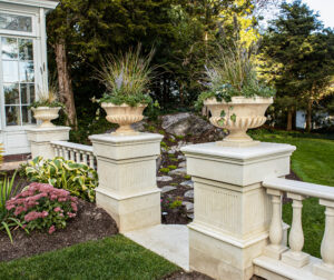 Marble columns with planters on top.