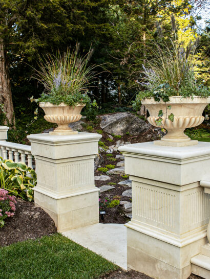 Marble columns with planters on top.
