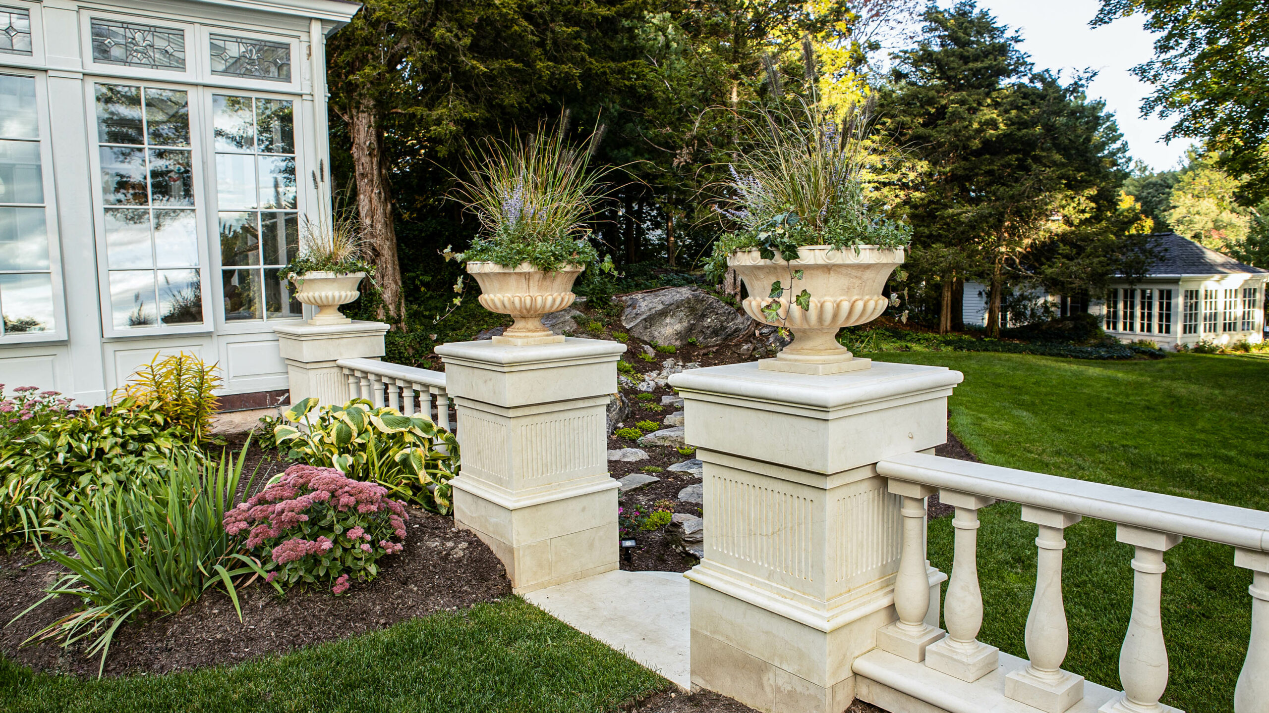 Marble columns with planters on top.