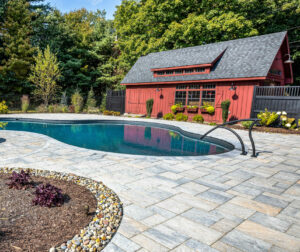 Pool with lounge chairs and a fire pit.