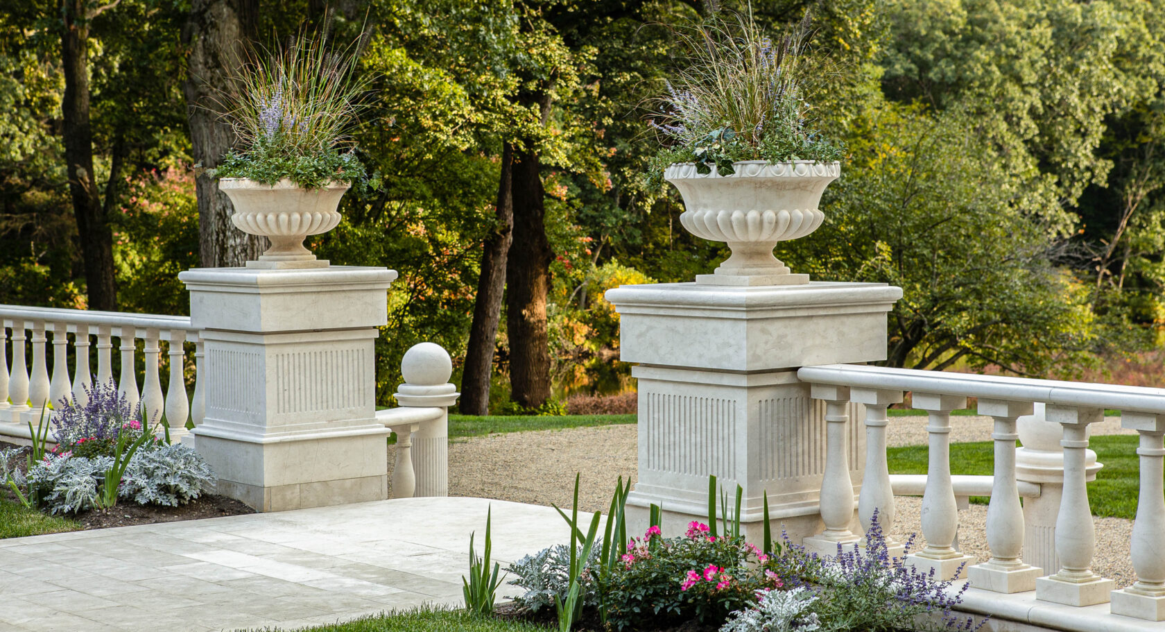 Close up of marble columns with planters on top.