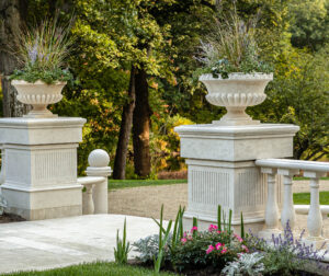 Close up of marble columns with planters on top.