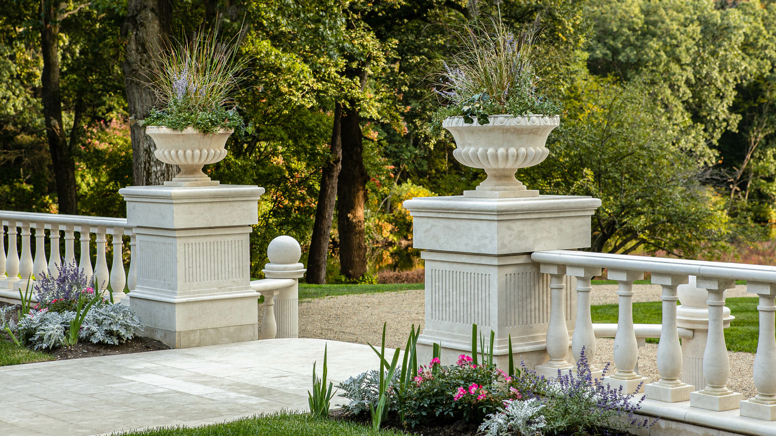 Close up of marble columns with planters on top.