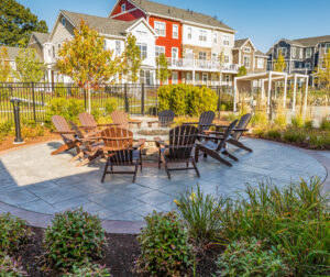 Chairs around a fire pit in a housing community.