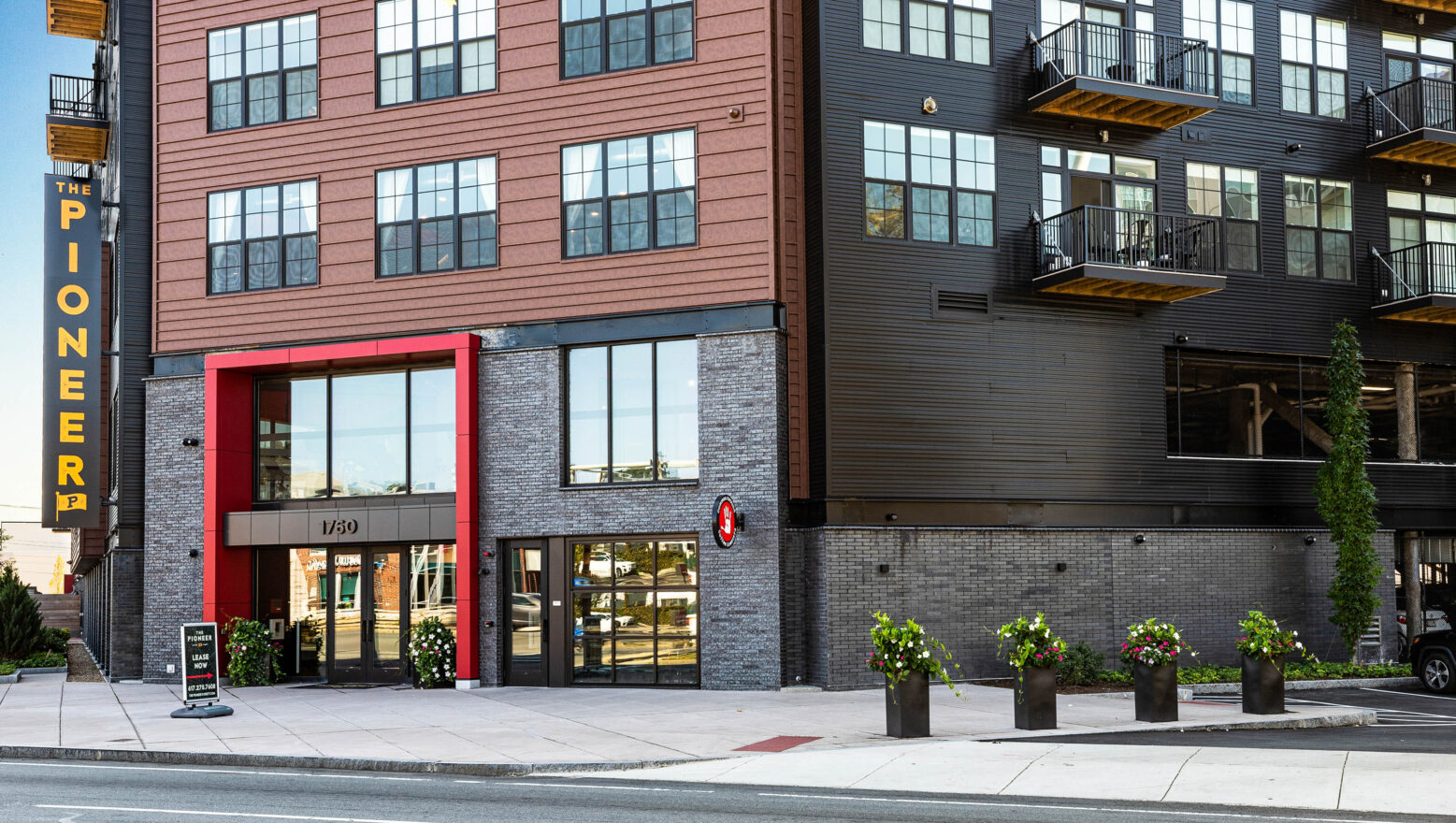 Front of Pioneer apartment building in Everett, MA. Sidewalks by Dex by Terra.