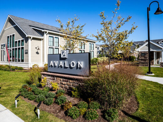 Avalon sign with plants around it.