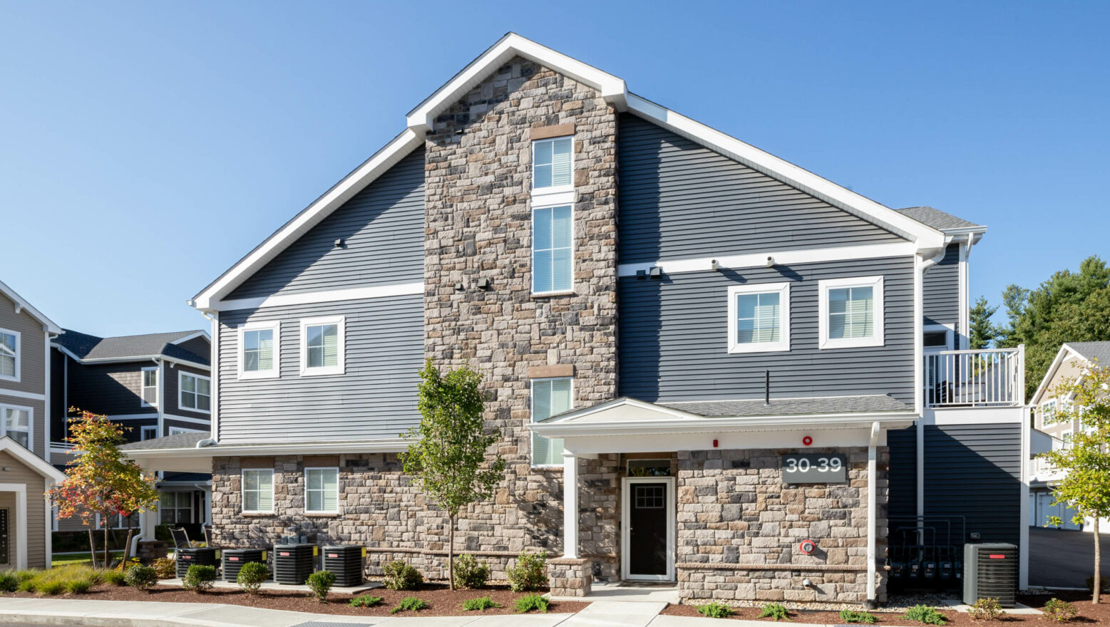 Commercial apartment building with stone veneer work completed by Dex by Terra in Massachusetts.