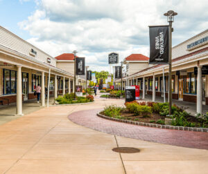 Planters and signs at the Wrentham shopping center.