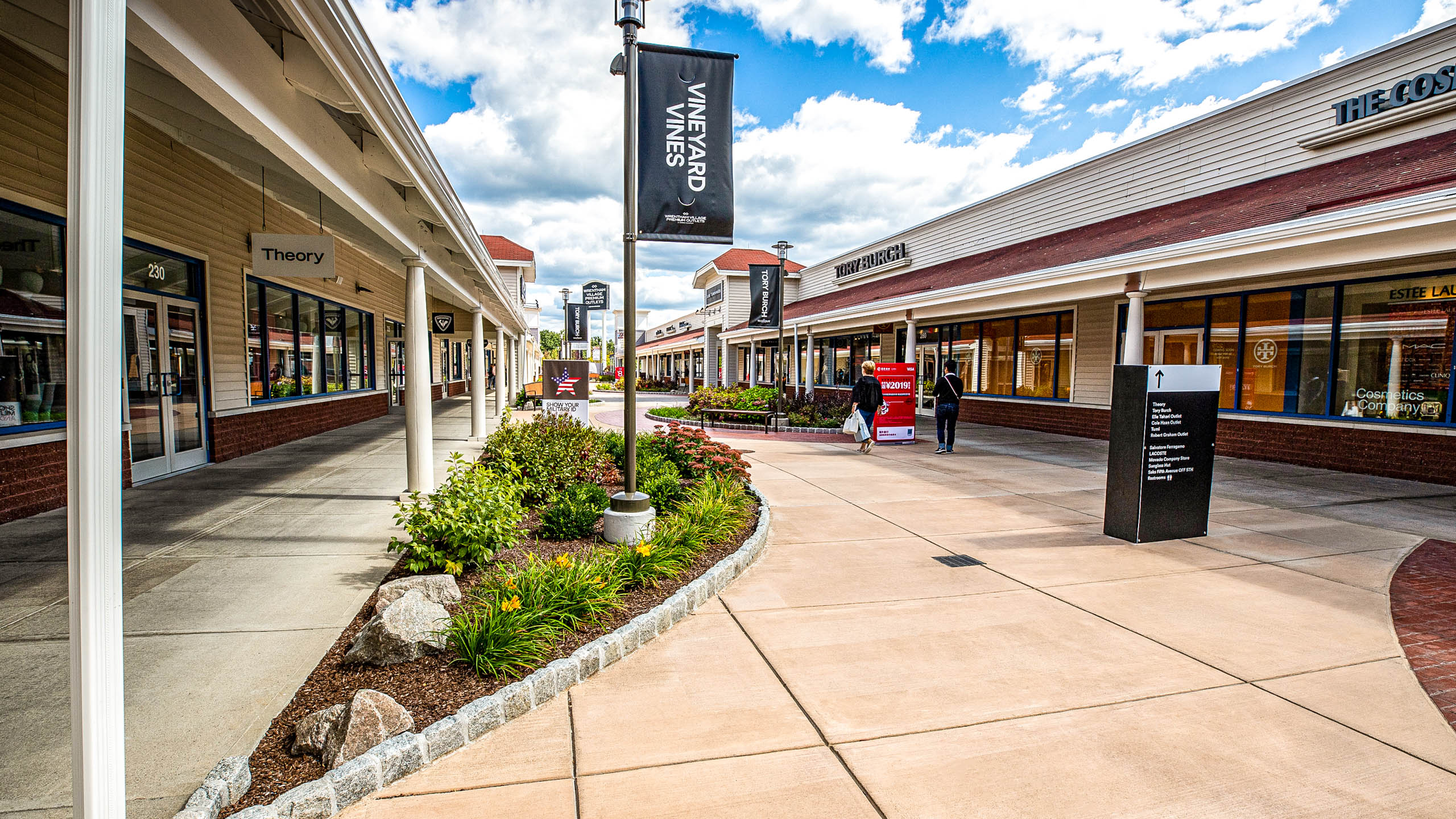 Planters and signs at the Wrentham shopping center.