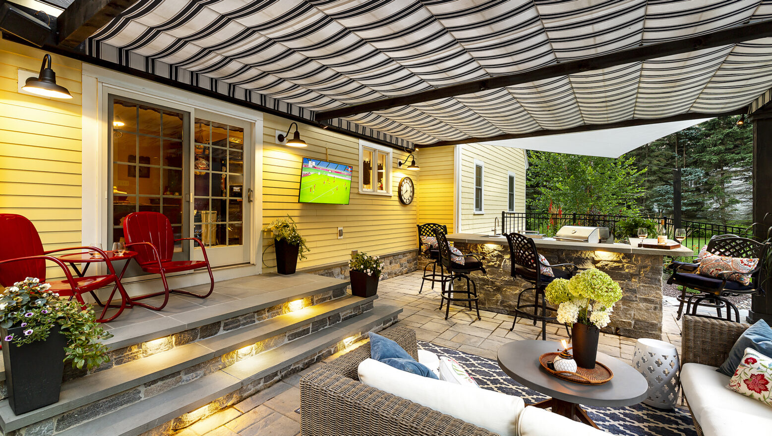 Patio with outdoor kitchen, and integrated LED lighting. Dex by Terra's residential hardscape/landscape project in Stow, MA.