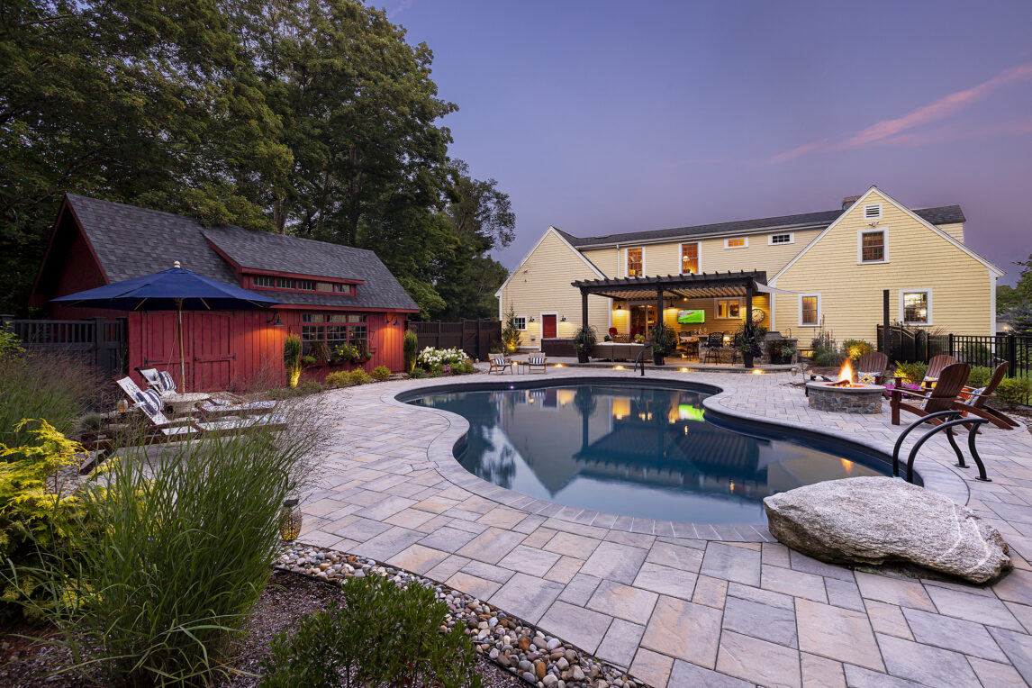 Paver Pool deck with Jump Rock and Fire Pit at Dex by Terra's Residential hardscape/landscape project in Stow, MA.