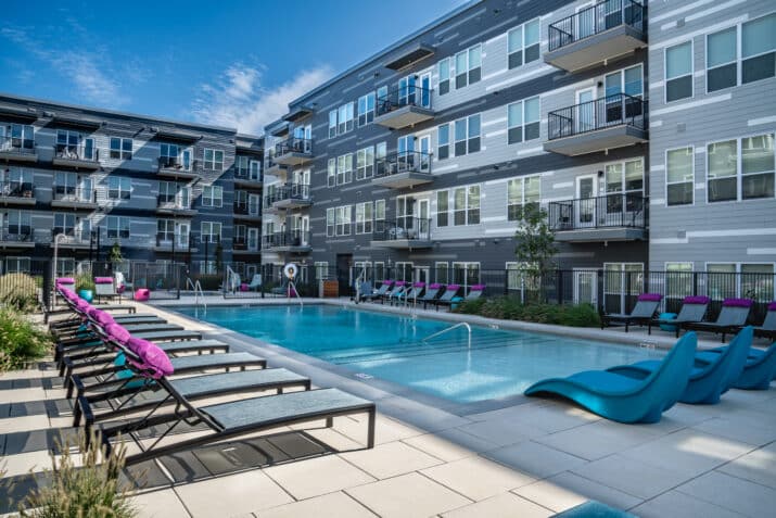 View of 3rd floor pool deck, built by Dex By Terra, with pool chairs at V2 Apartments in Chelsea, Massachusetts.