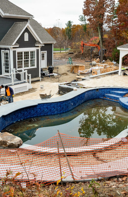 Backyard during the hardscaping construction around the pool. Dex by Terra project in Sterling, Massachusetts