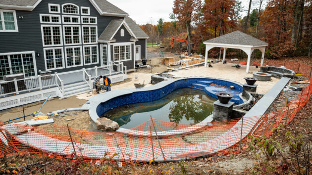 Backyard during the hardscaping construction around the pool. Dex by Terra project in Sterling, Massachusetts