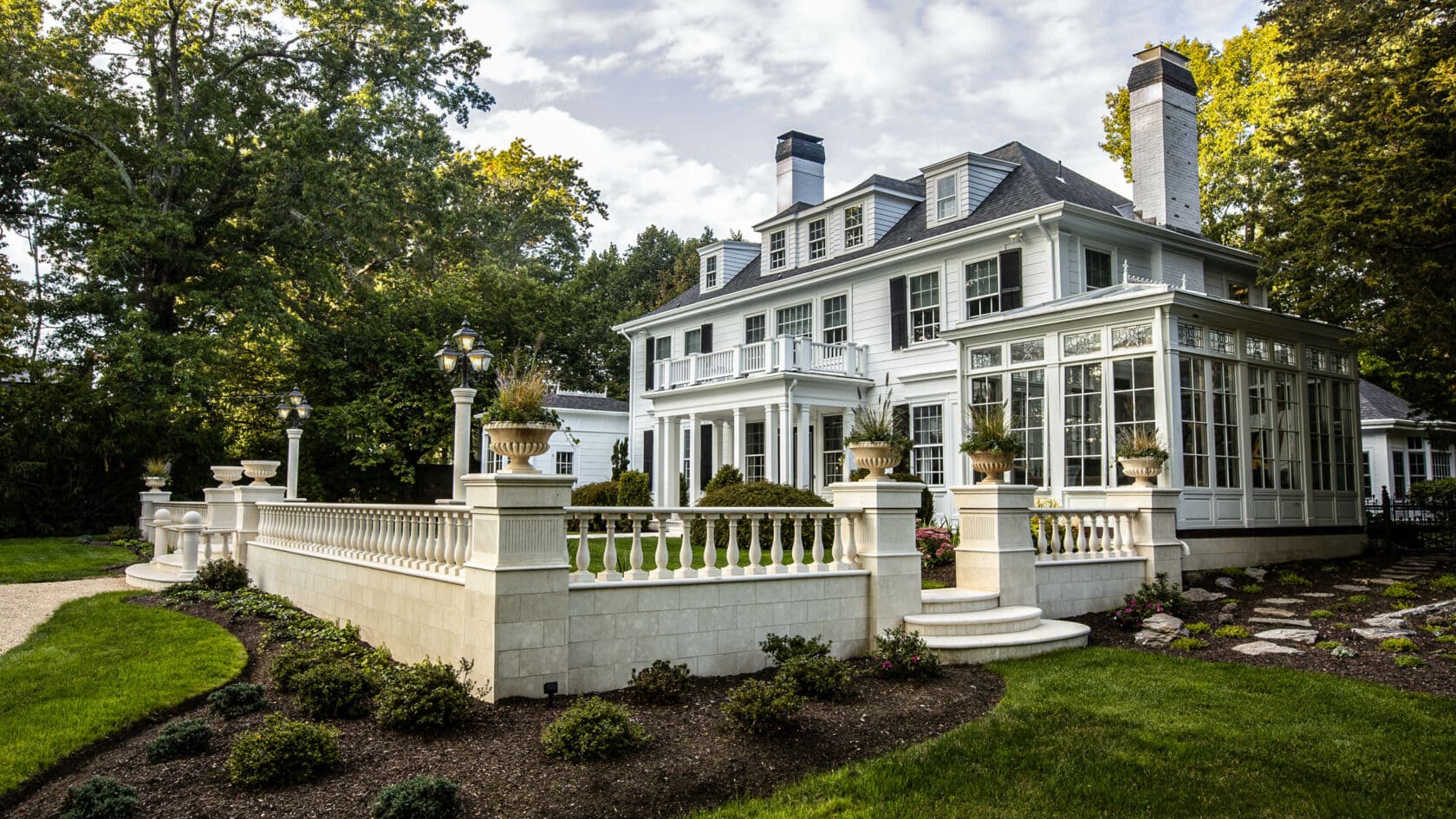 Side of the Gibson house with marble fencing and elegant landscaping.