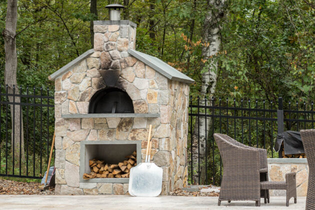 Outdoor, wood-fired, stone pizza oven designed and built by Dex by Terra in Hudson, Massachusetts.