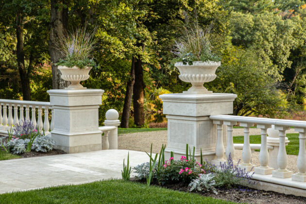 Close up of marble columns with planters on top.