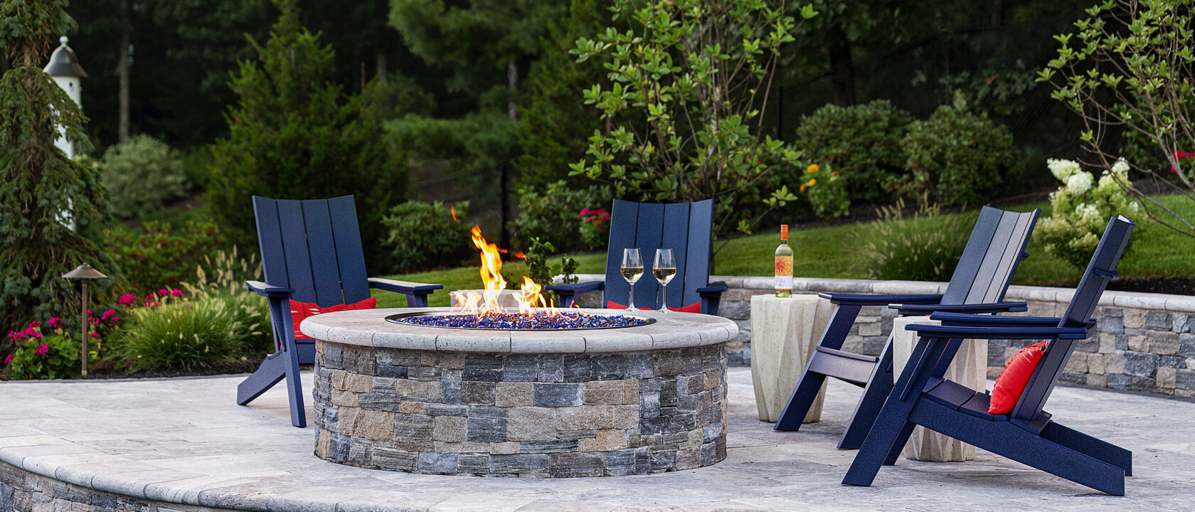 Gas fire pit with chairs and a bottle of wine. Dex by Terra Fire Feature project in Norfolk, MA.