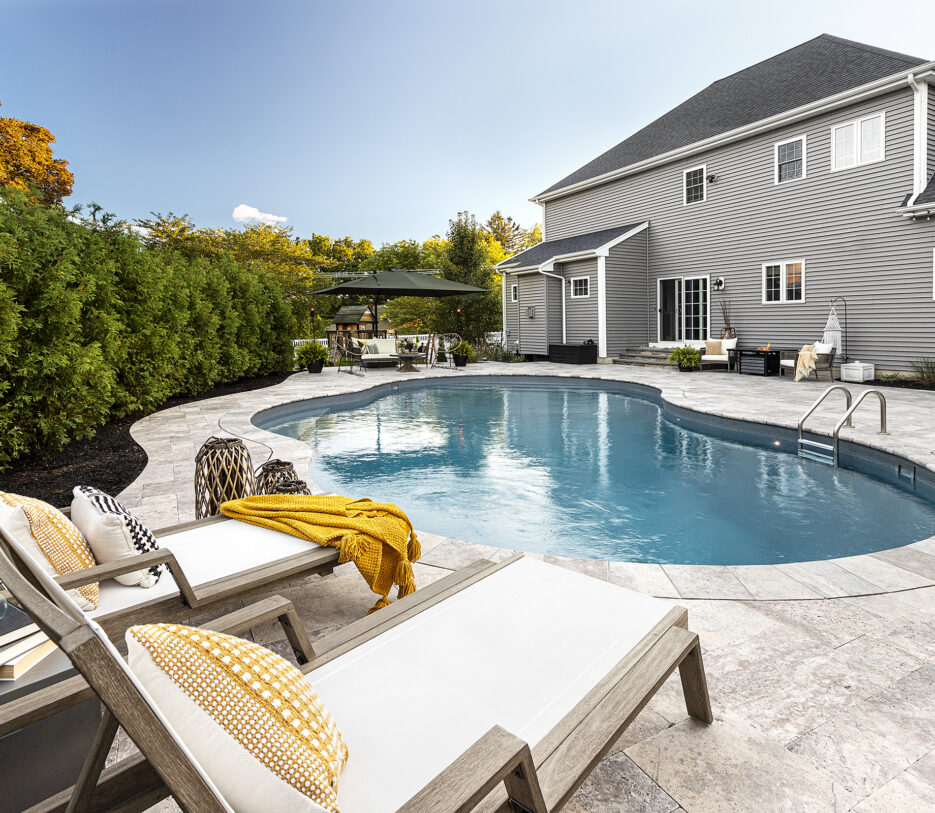 Lounge chairs by the pool. Dex by Terra Residential Landscape Design & Build Project in Shrewsbury, Massachusetts