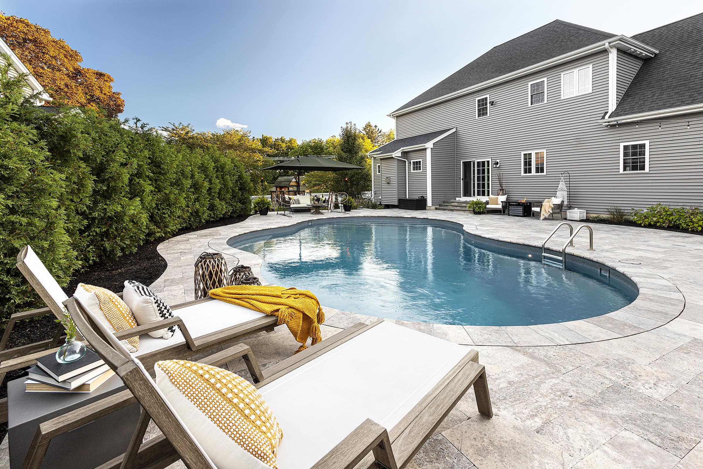 Lounge chairs by the pool. Dex by Terra Residential Landscape Design & Build Project in Shrewsbury, Massachusetts