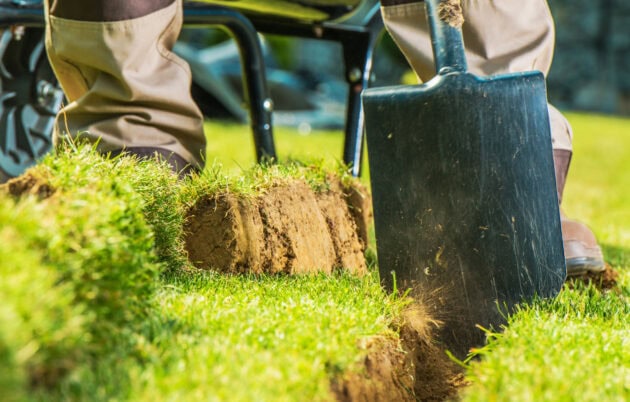 Digging a trench for landscape lighting or irrigation installation.