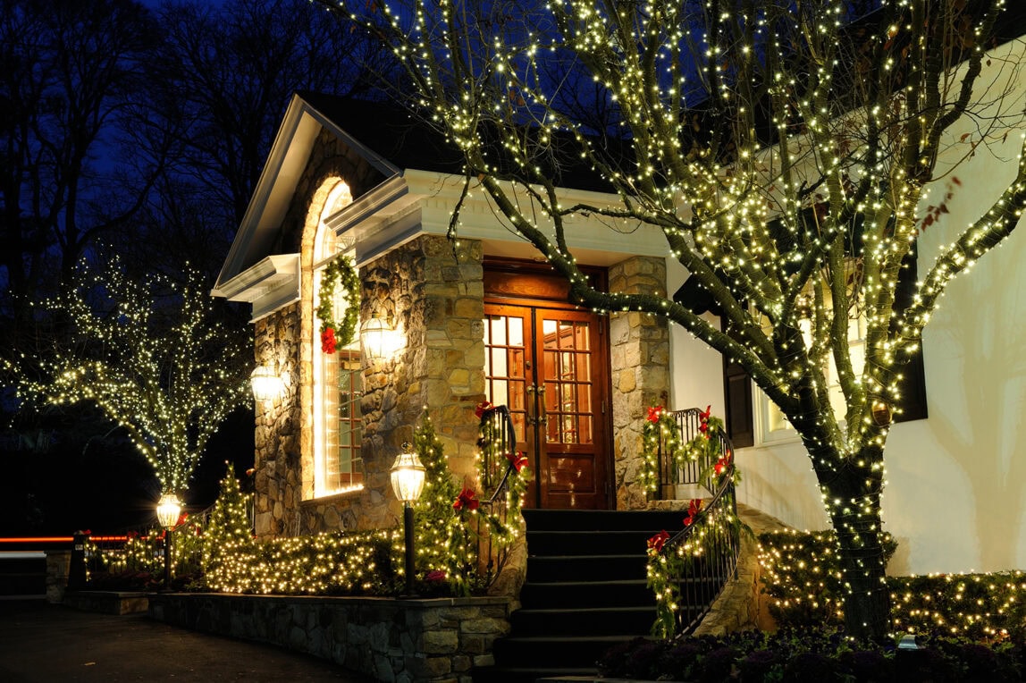 Front steps of a house with Christmas decor.