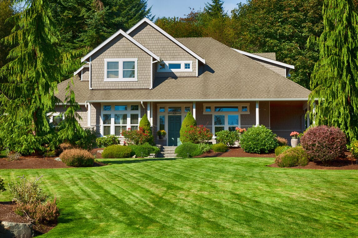 Landscaped property with turf, and flower beds.