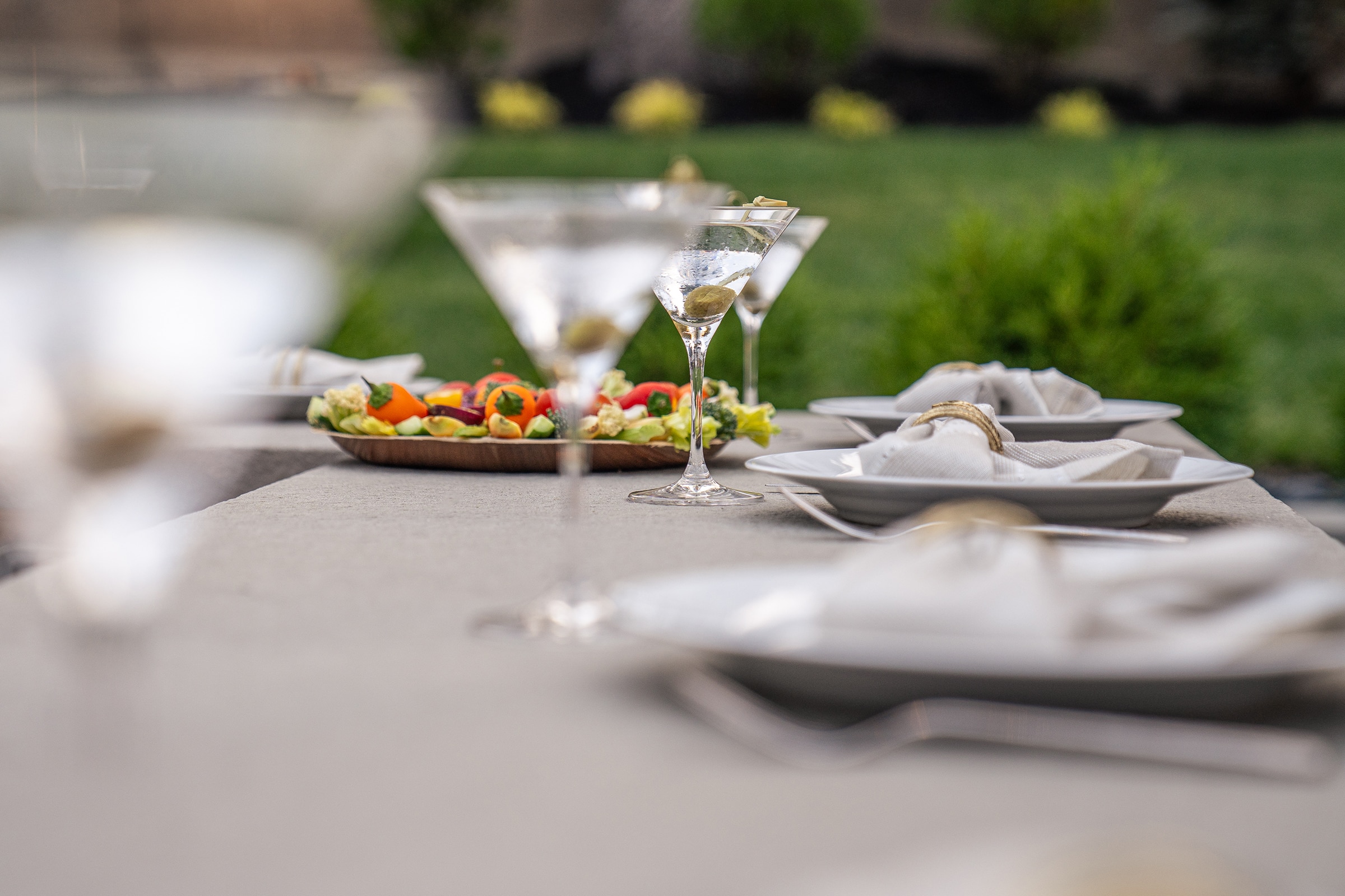 Martinis and place settings sit on an outdoor kitchen bar in Needham, MA.