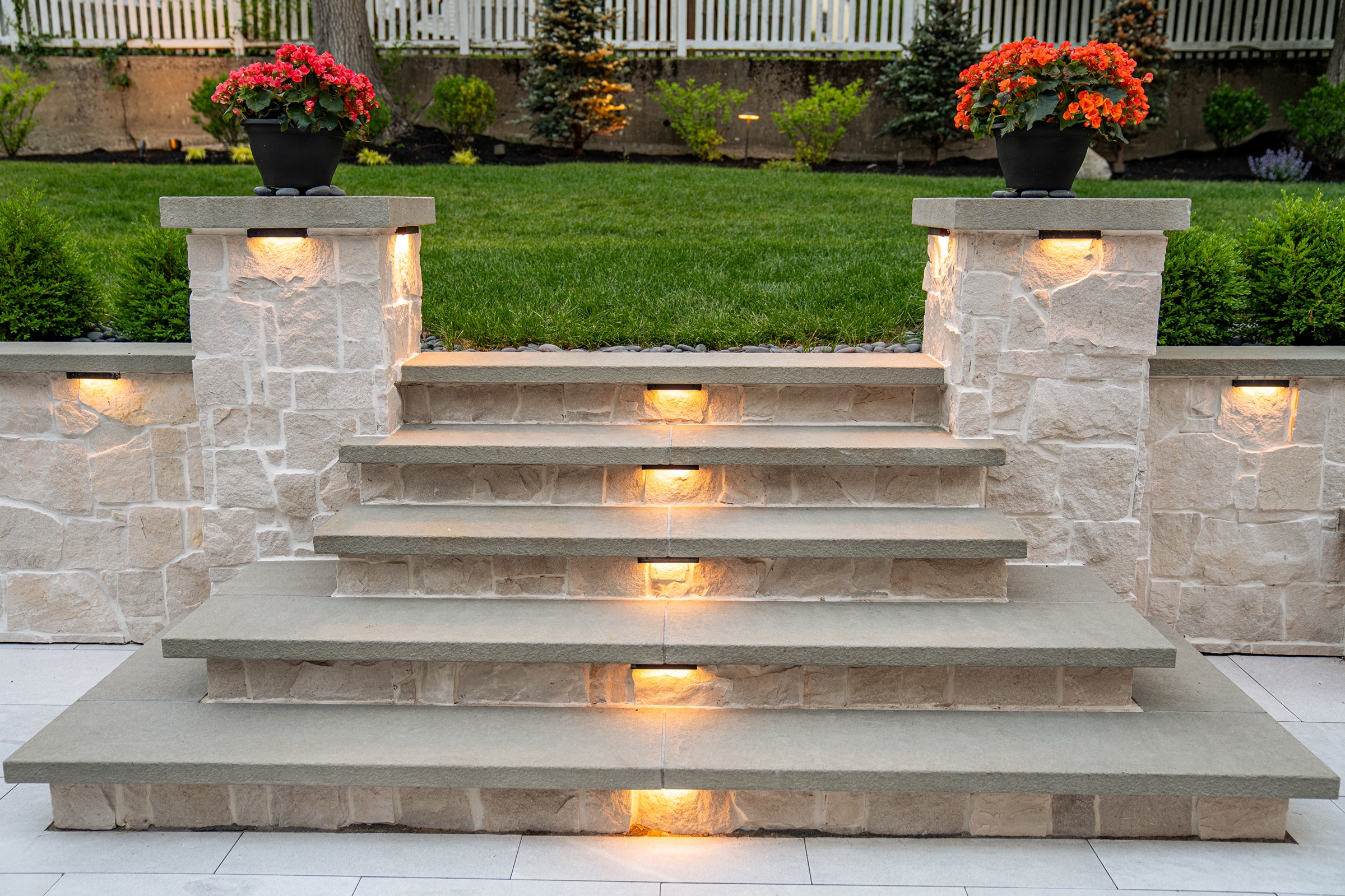 Stone steps with built-in low voltage landscape lighting in Needham, MA.