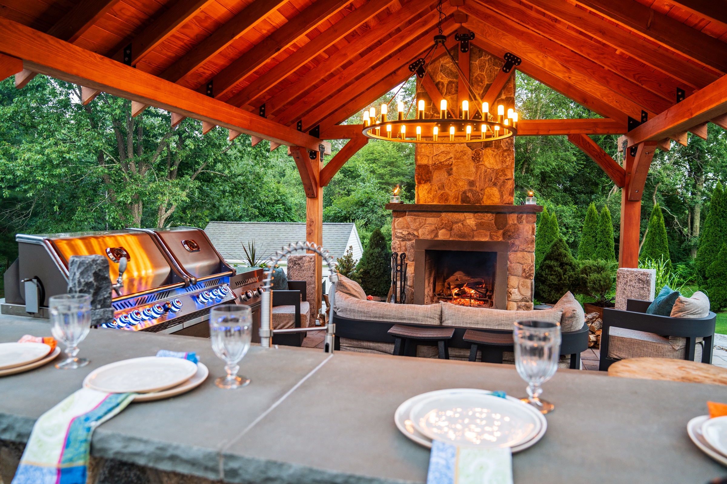 Our clients can ejnoy their outdoor fireplace while grilling food for guests under their pergola.