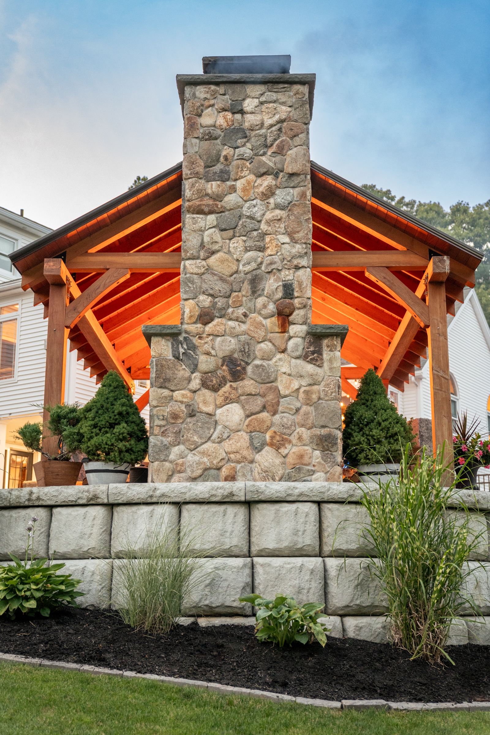 New England Rounds stone veneer was used to create the outdoor fireplace that warms the relaxation area under the pergola.