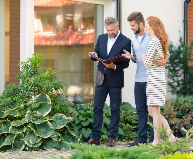 A Dex by Terra Landscape Designer consults with clients about the landscaping at their home.