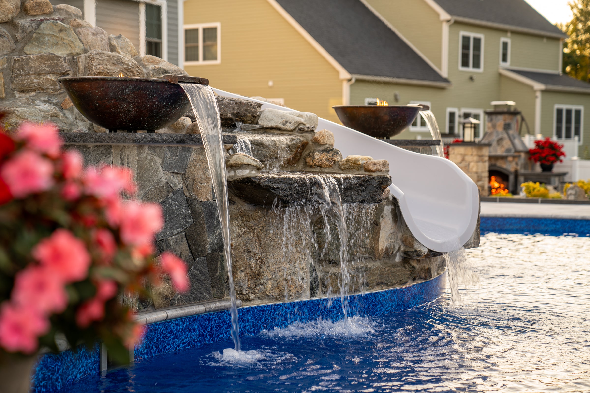 Water and fire features flank the custom waterslide built by Dex by Terra in Grafton, Massachusetts.