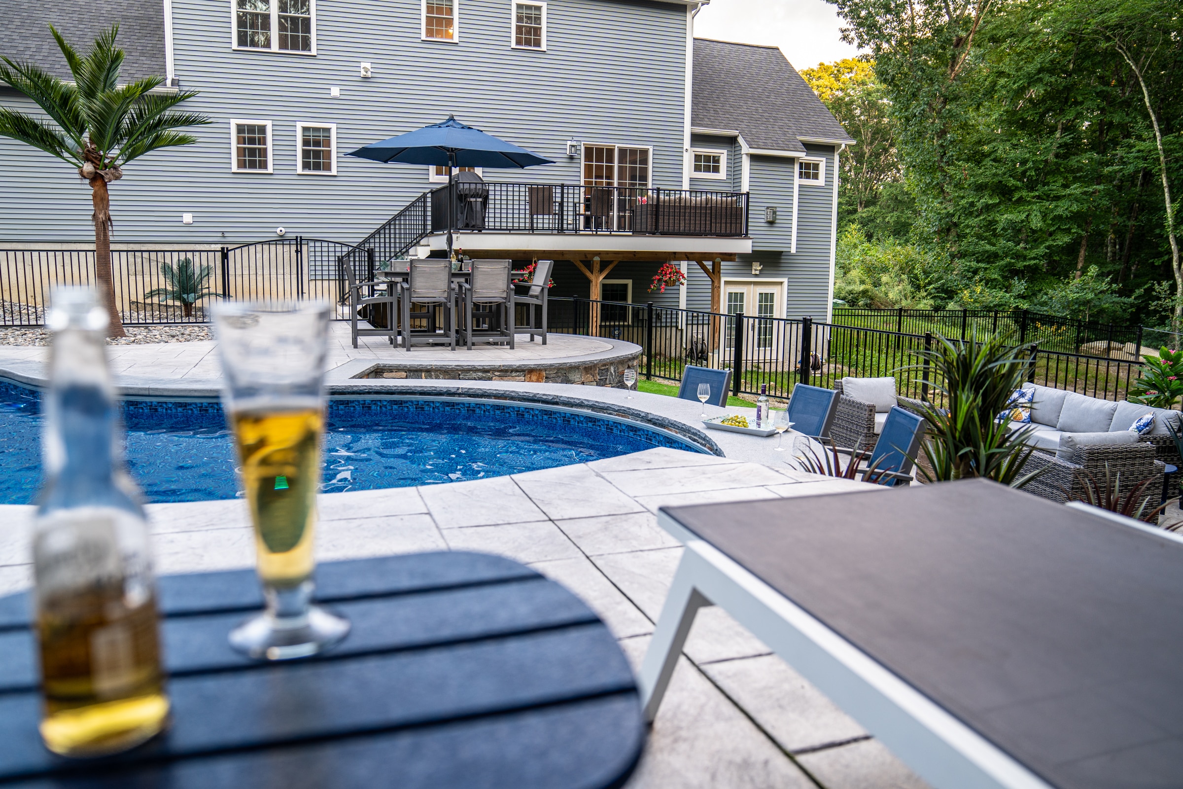 A view of the poolside bar from the sundeck at this Dex by Terra stamped concrete pool deck project in Northbridge, Massachusetts.