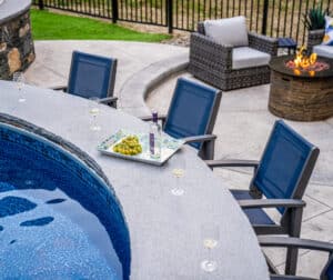 A granite cap was used to create the surface of the poolside bar at this Dex by Terra hardscape in Northbridge, Massachusetts.