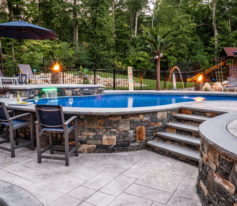 Dex by Terra created an elevated pool deck with a sunken fire pit lounge to accommodate a significant slope in the client's yard.