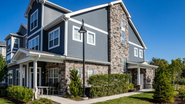 Stone veneer masonry work at luxury apartments in Massachusetts. Dex by Terra Commercial Hardscape project.