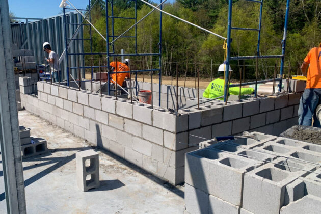 Workers building an elevator shaft.