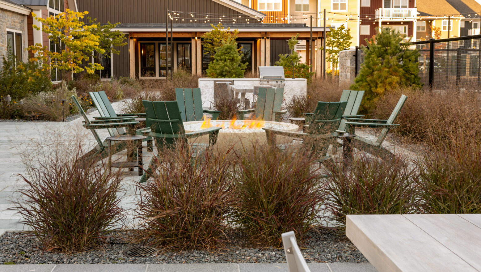 Chairs around a fire pit in a commercial setting.