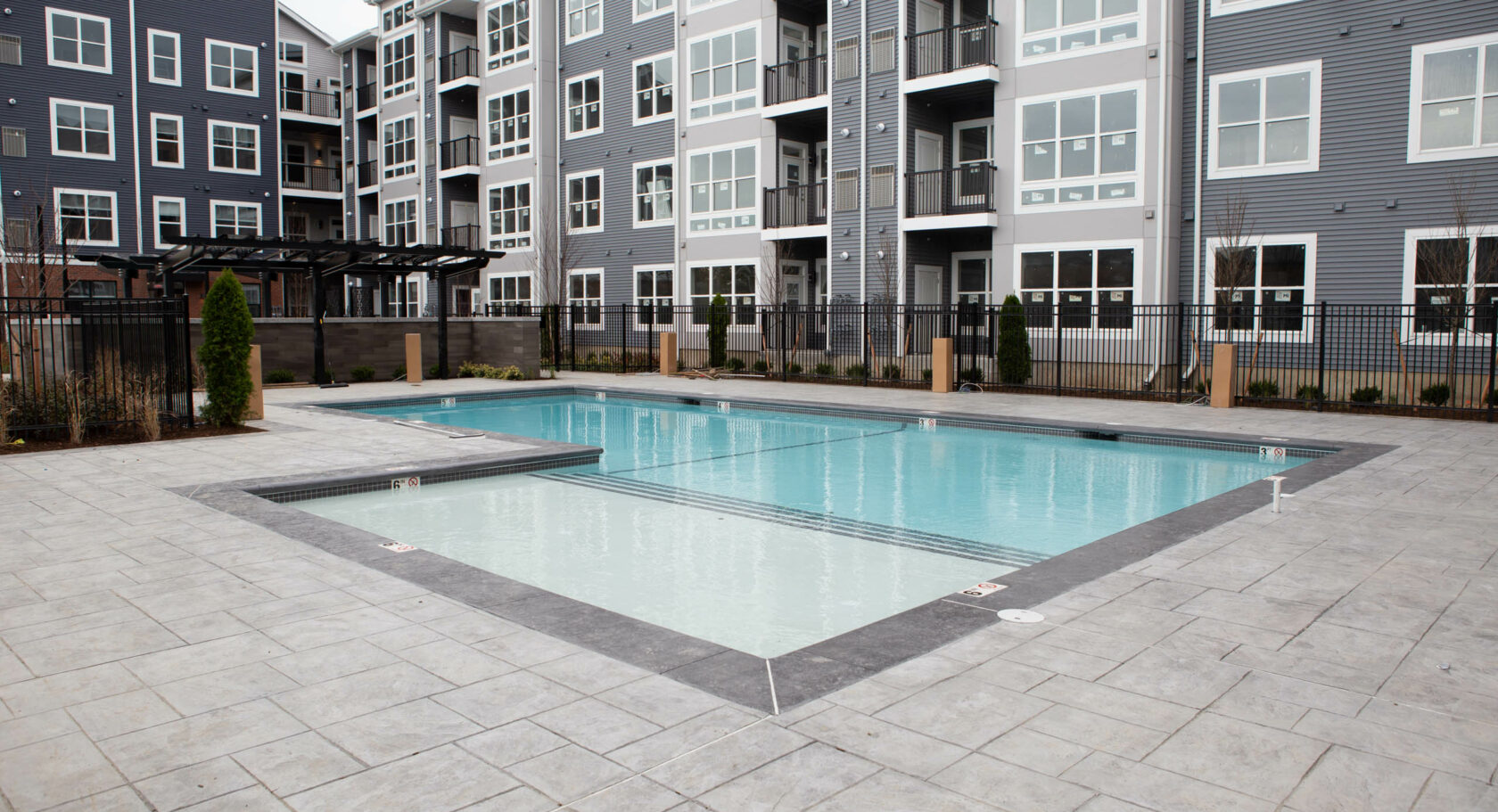 Stamped concrete pool dock in a Massachusetts apartment complex. Commercial concrete work by Dex by Terra.