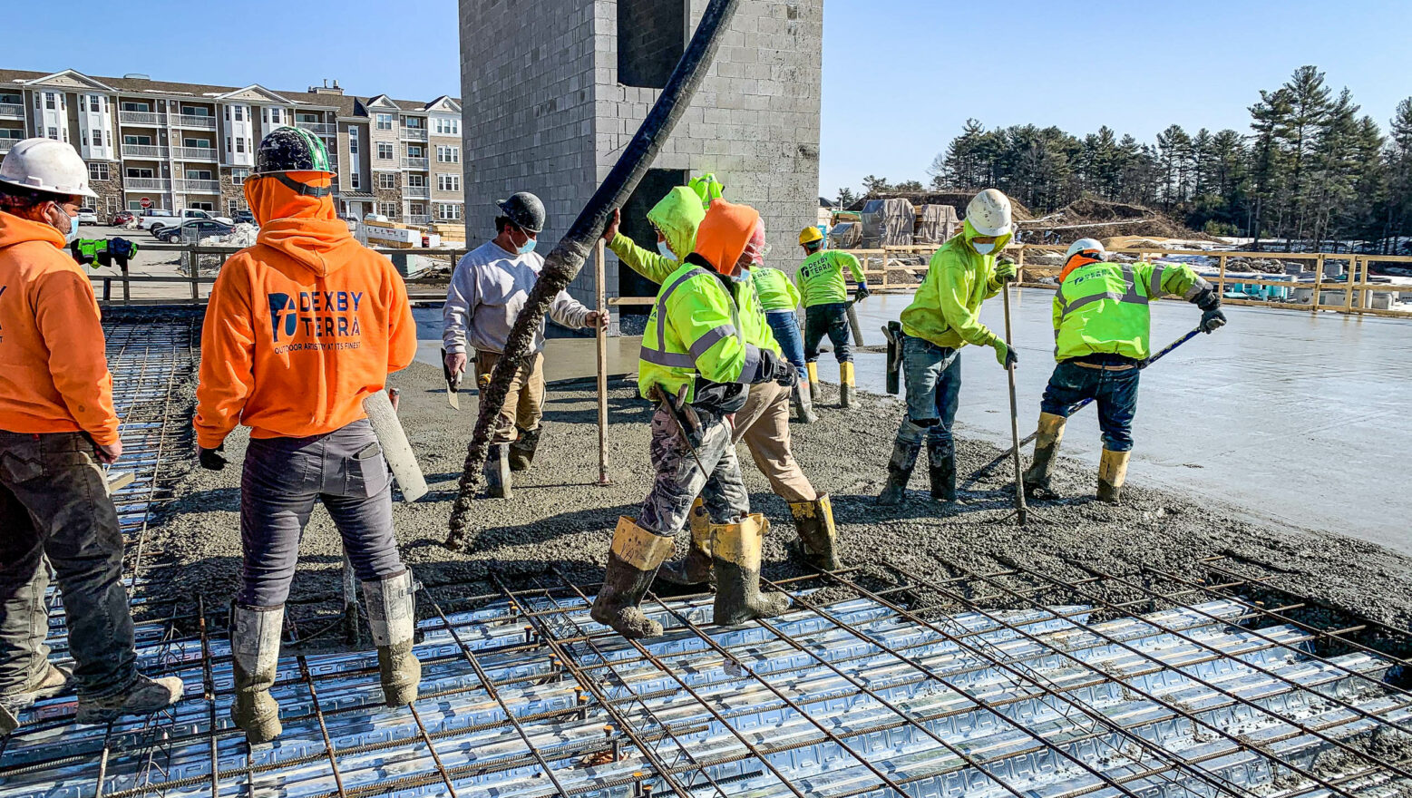 Commercial Site & Construction Services - Workers pouring concrete.