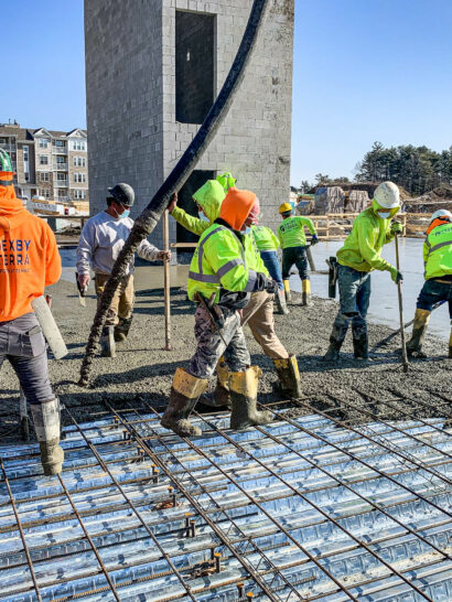 Commercial Site & Construction Services - Dex by Terra workers pouring concrete slab with rebar.