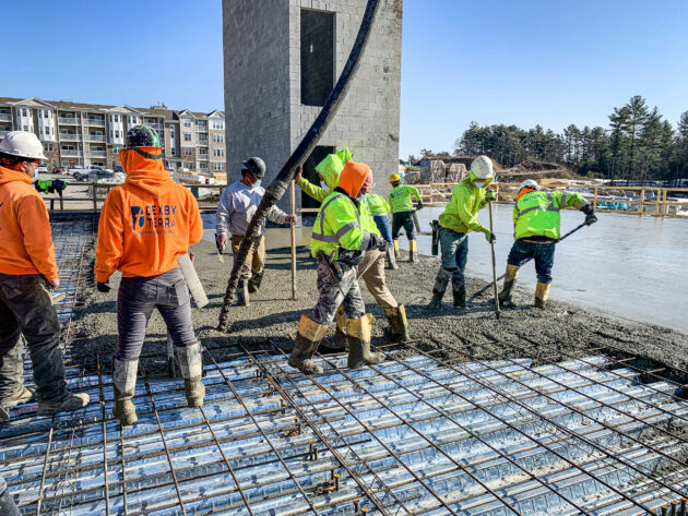 Commercial Site & Construction Services - Dex by Terra workers pouring concrete slab with rebar.