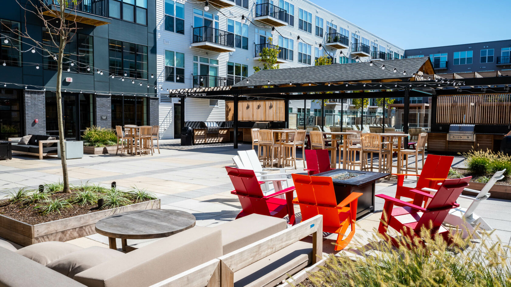 Apartment outdoor space with tables and chairs.