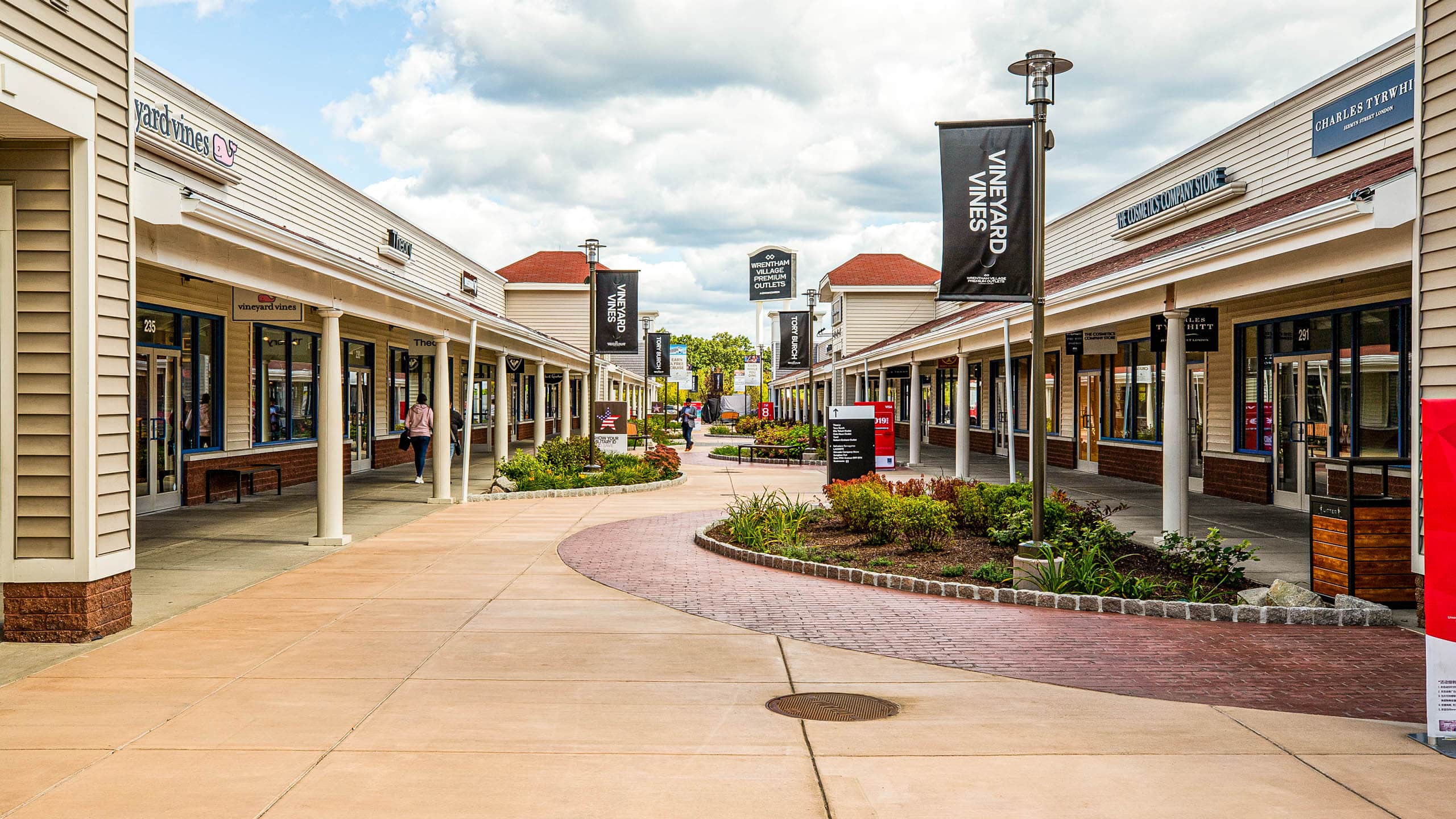 Planters and signs at the Wrentham shopping center.