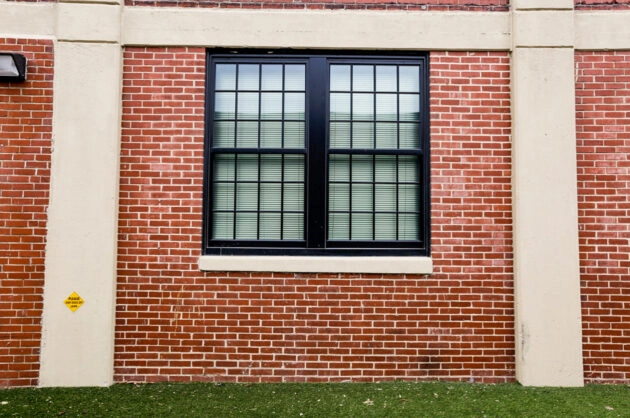 Exterior brick wall with window after restoration & repointing. Dex by Terra Commercial Masonry project in MA.